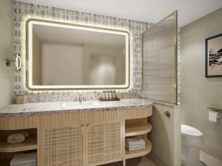 A modern bathroom featuring a backlit rectangular mirror, woven wood vanity with open shelving, patterned backsplash, and a glass-front cabinet.
