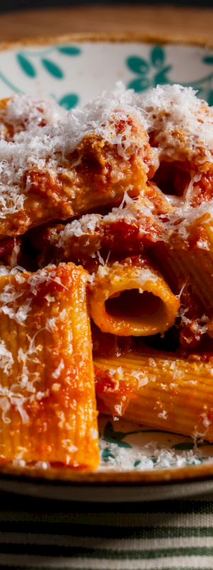 Crispy fried chicken wings with a glossy glaze, sprinkled sesame seeds, served on a blue plate. End.